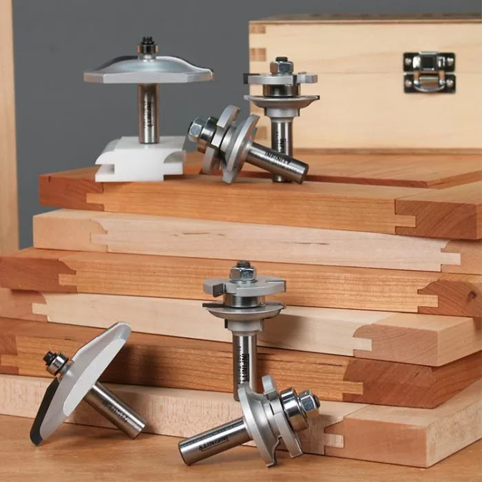 Router bits for woodworking joinery displayed on dovetail jointed wood boards