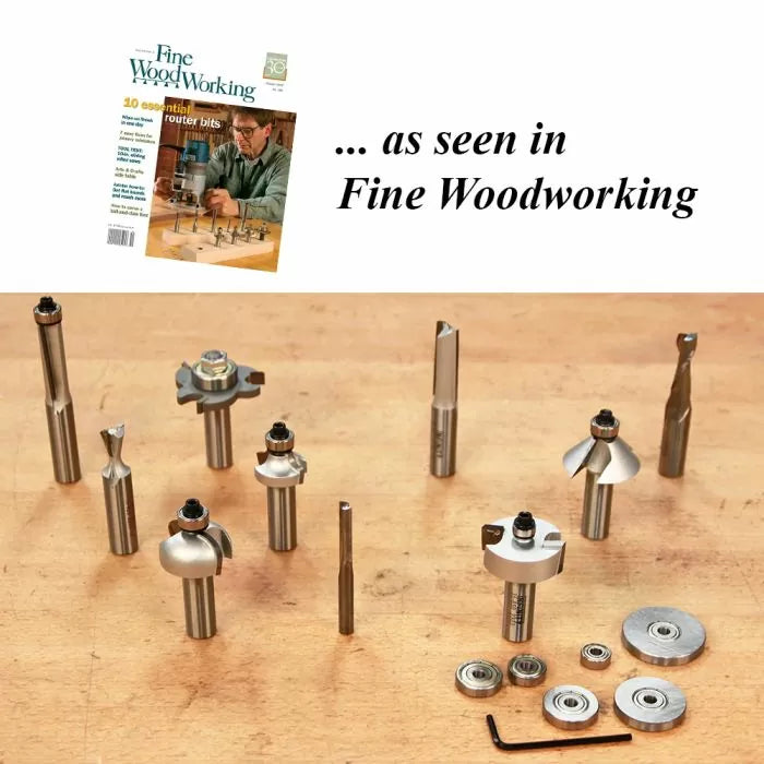 Assorted woodworking router bits, bearings, and wrench displayed on a wooden table.