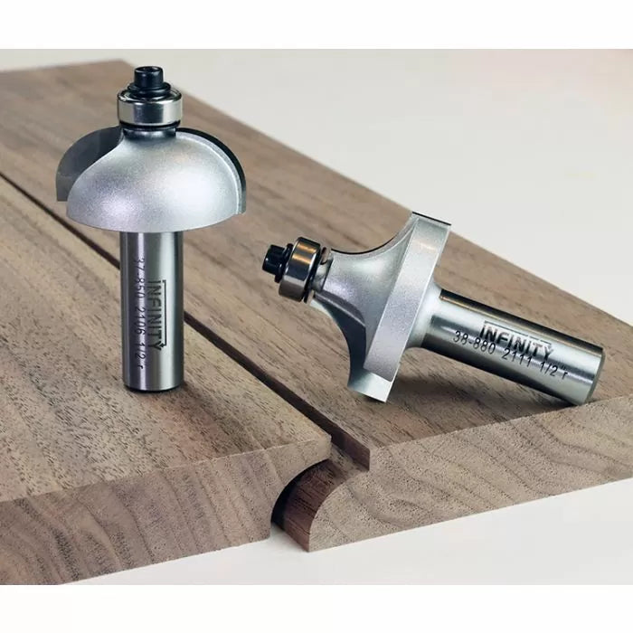 Roundover router bits with bearings on wood, showing smooth rounded edge profiles.