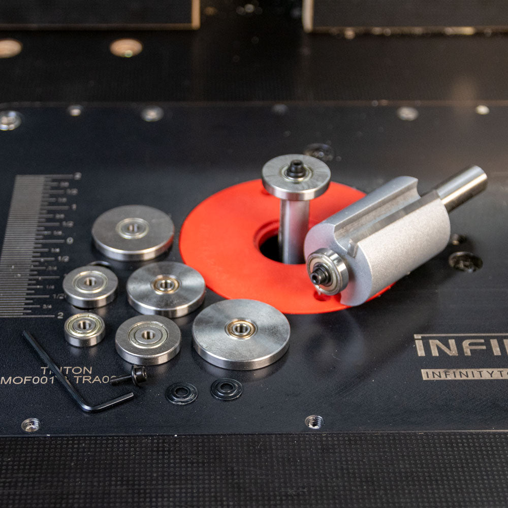 Router bit with multiple ball bearing guides and hex key on a router table top