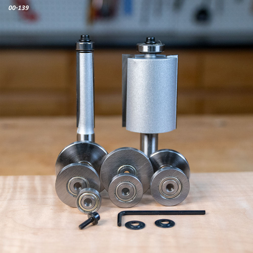 Woodworking router bits and bearings set with wrench and washers on workbench