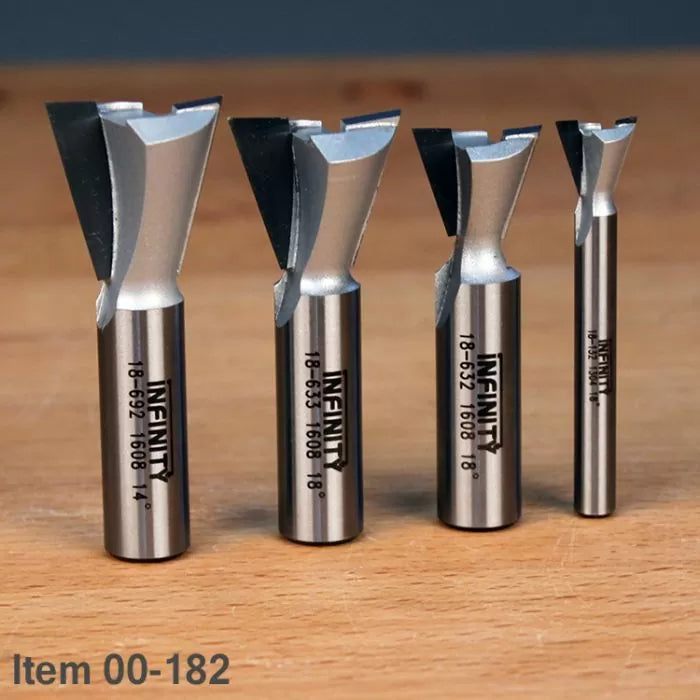 Set of four dovetail router bits for woodworking on a wooden surface, item 00-182.