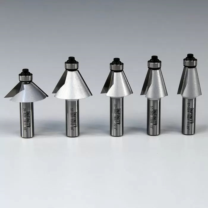 Five carbide-tipped router bits for woodworking displayed in a row on a plain background