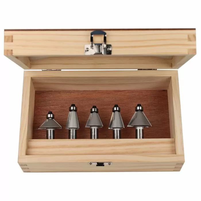 Woodworking router bit set in open wooden case, five metal bits organized in a row