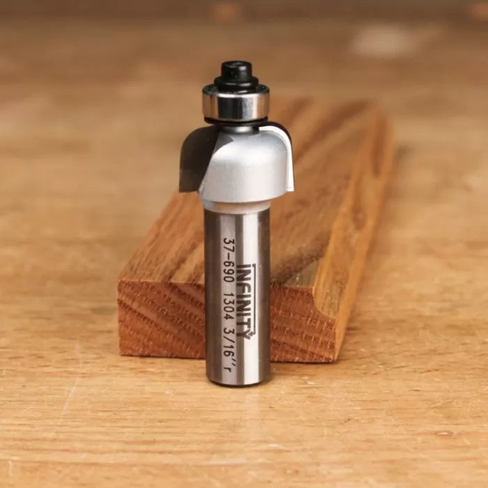 Roundover router bit with bearing guide on wood surface, woodworking tool for smooth edges