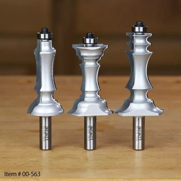 Three metal woodworking router bits with decorative profiles on a wooden surface