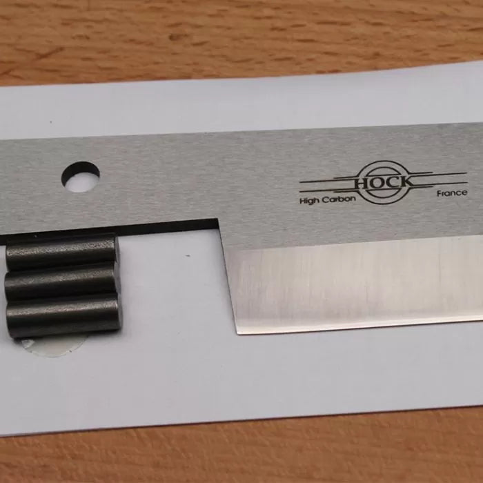 High carbon steel woodworking plane blade with sharp edge on wood surface