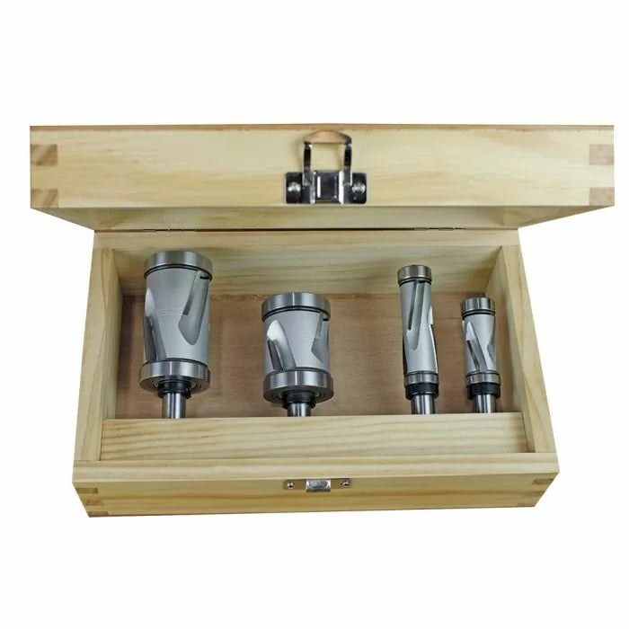Set of four woodworking router bits in a wooden storage box