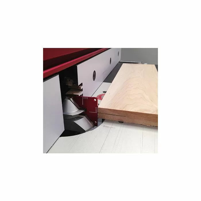 Woodworking router table with fence, router bit, and wood board setup