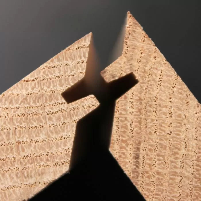 Close-up of two interlocking wooden dovetail joints for woodworking joinery