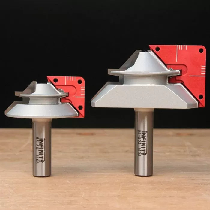 Two large chamfer router bits with red setup blocks on a wooden surface, ideal for woodworking.