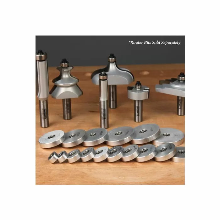 Assorted woodworking router bits and roundover bearing guides on a wooden workbench