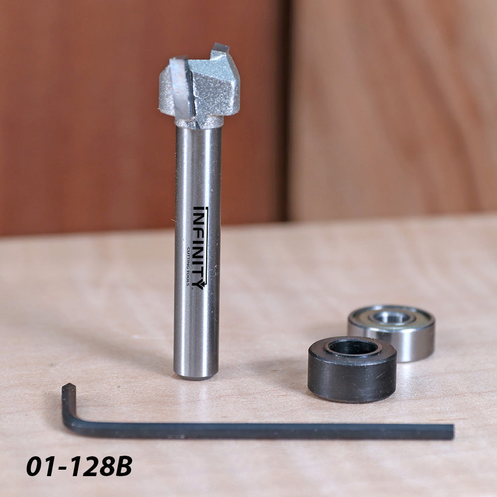 Carbide woodworking router bit with bearings, hex key, and model 01-128B on workbench