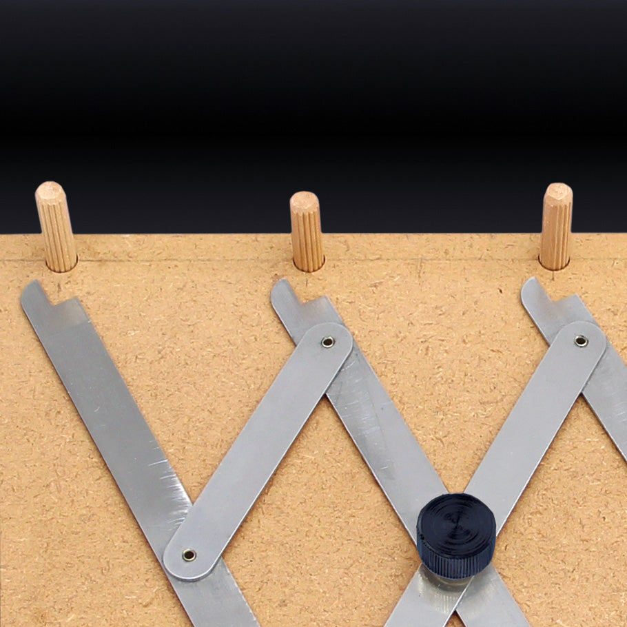 Dowel jig marking tool on plywood with inserted wooden dowels for precise woodworking layout