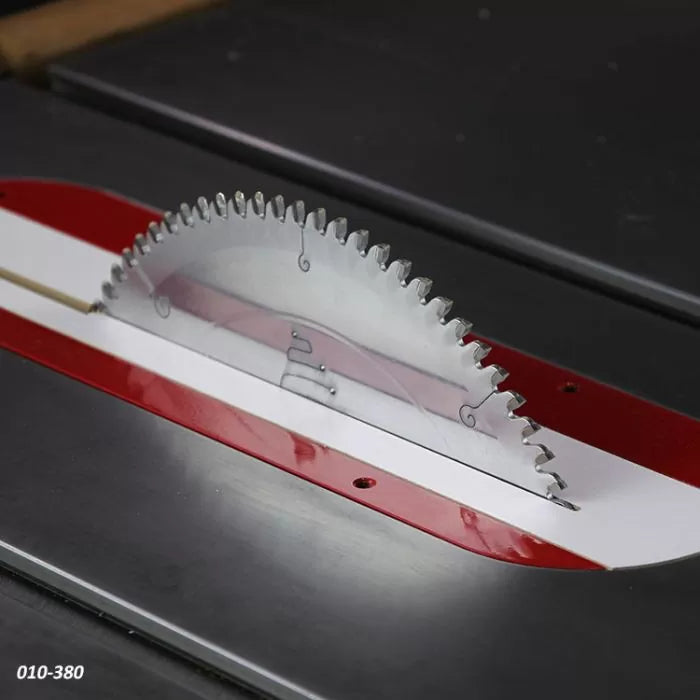 Table saw blade installed in a saw table with red and white insert, woodworking tool
