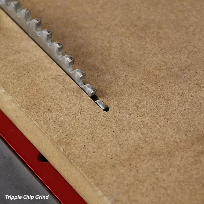 Triple chip grind saw blade cutting MDF on a table saw, close-up woodworking tool