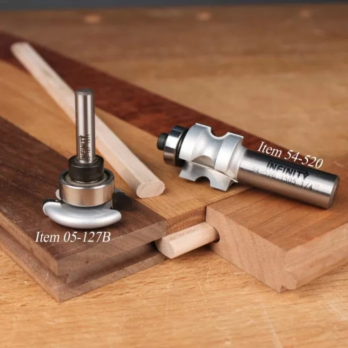 Woodworking router bits for joinery on hardwood boards, labeled as item 05-127B and 54-520.