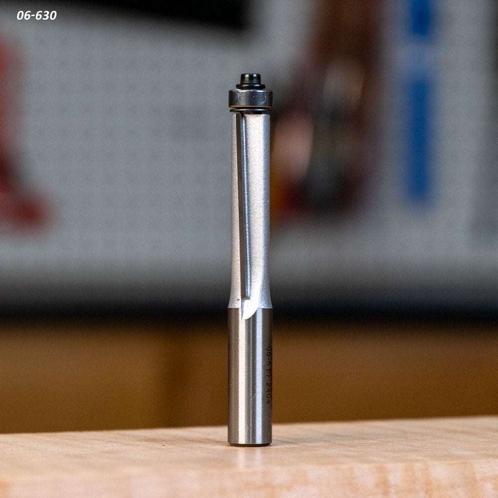 Straight router bit with bearing for woodworking on a workbench