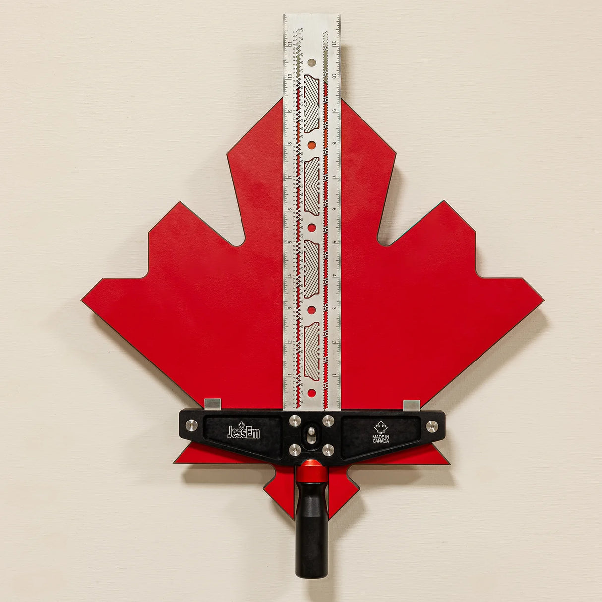 Precision woodworking router table fence tool with red maple leaf backplate and ruler guide