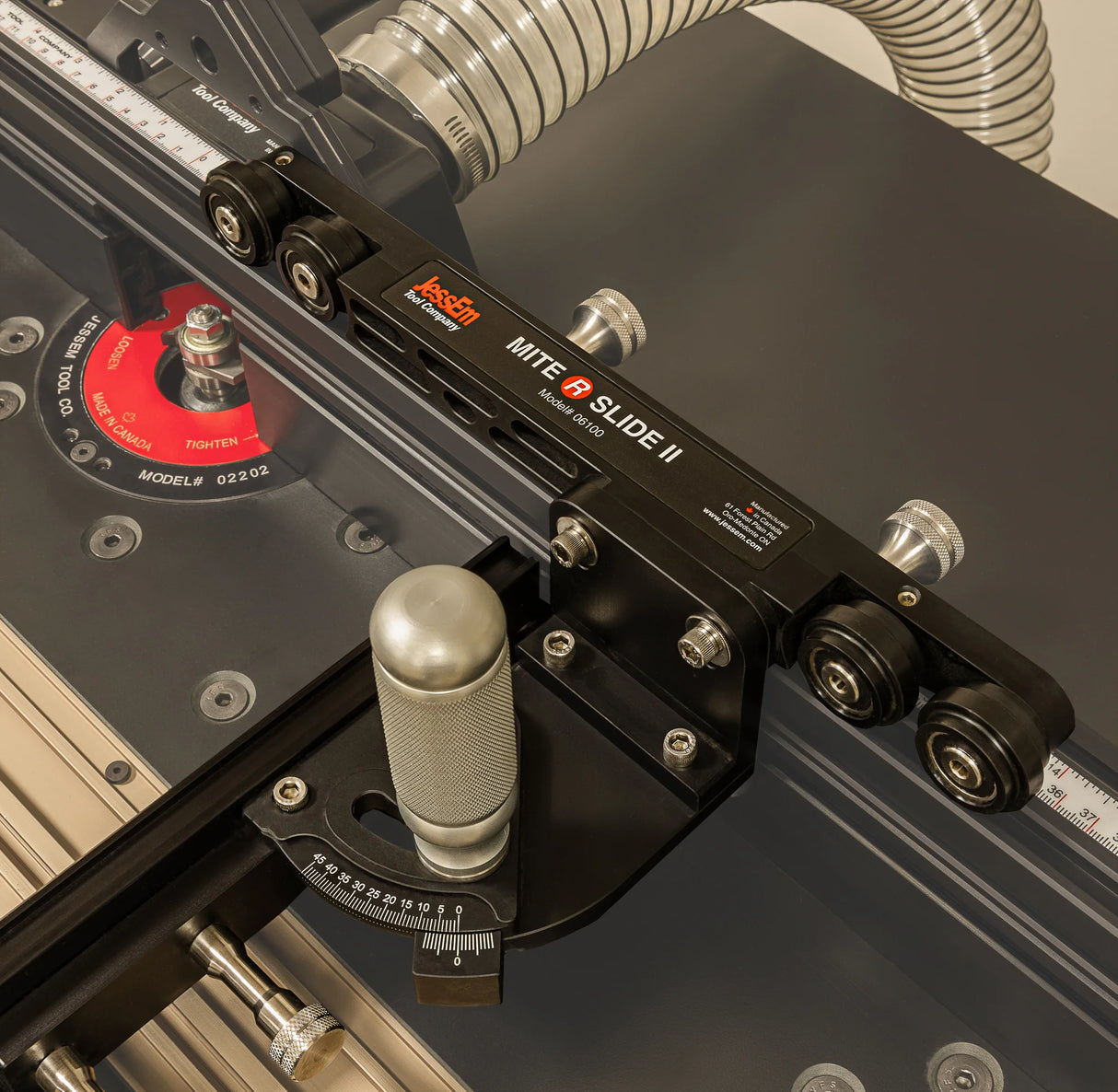 Precision router table jig with angle adjustment and dust collection hose for woodworking.