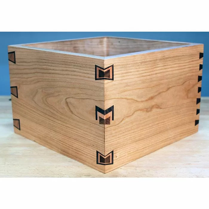 Wooden box with butterfly spline joints and dovetail corners on a workbench