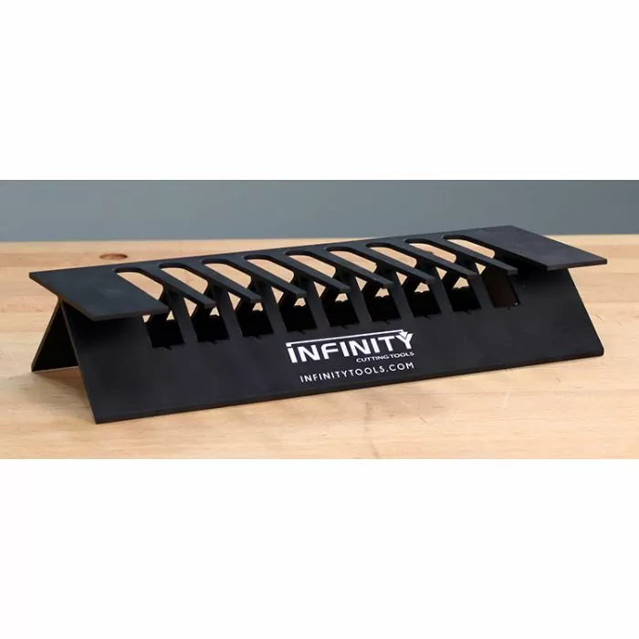 Black woodworking featherboard jig for saws, displayed on a wooden workbench.
