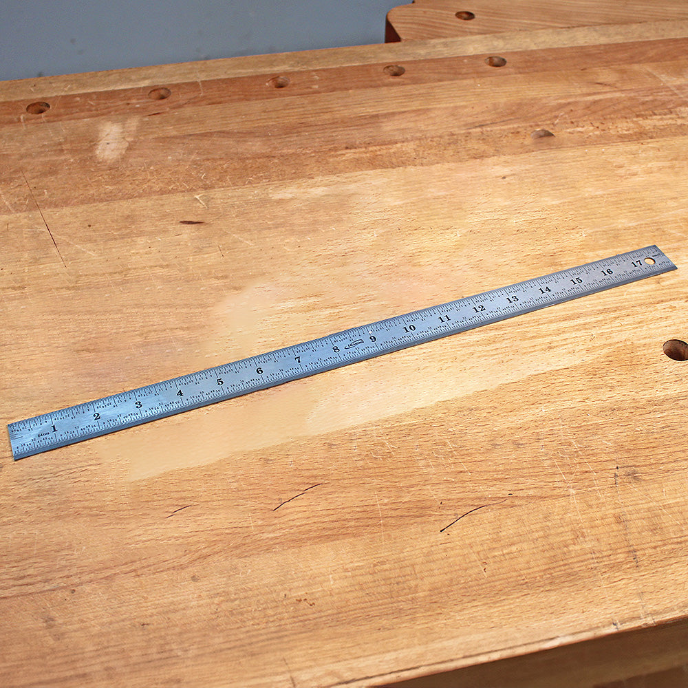 Stainless steel ruler on a wooden workbench, woodworking measuring tool