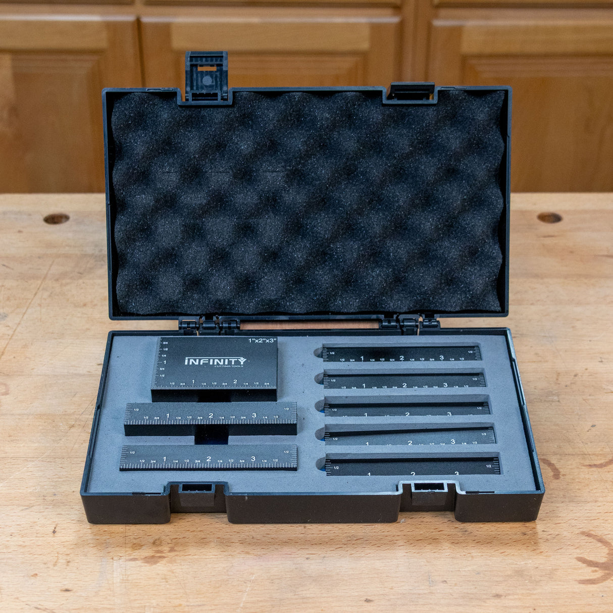 Infinity Tools precision setup blocks fitted in their foam-lined storage case on a workbench