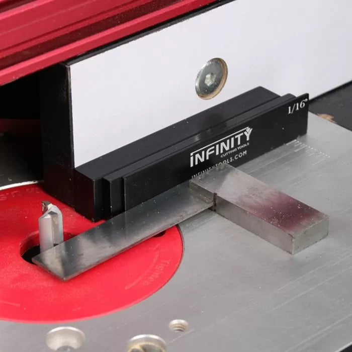 Router table setup with height gauge block, router bit, and aluminum fence for woodworking precision.