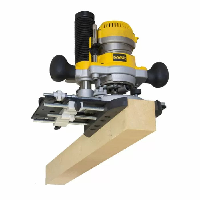 Plunge router with edge guide attached to a wooden board, woodworking tool in use
