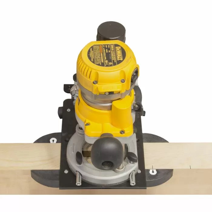 Woodworking router with guide attached to wooden board, top view