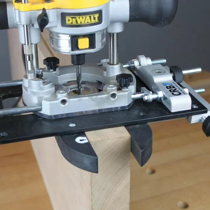Woodworking router with edge guide attachment cutting precise groove in wood board