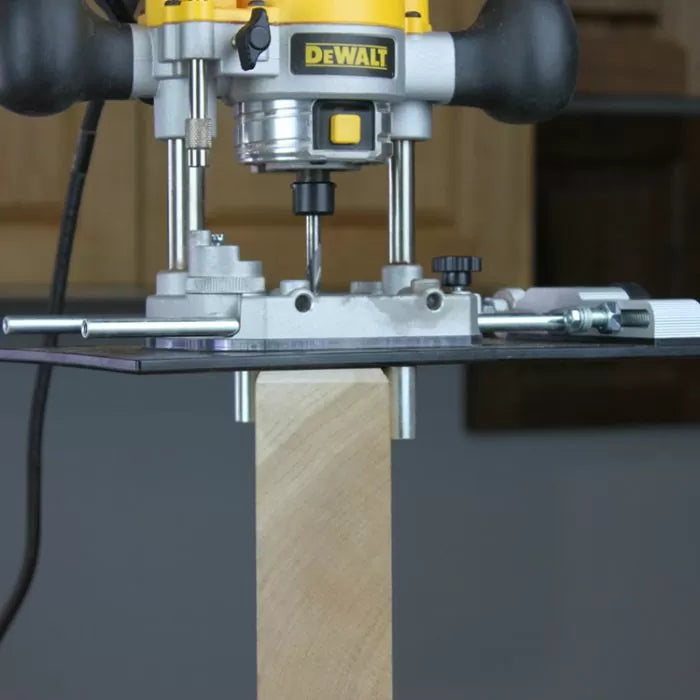 Plunge router with straight bit cutting edge on wooden board, woodworking tool setup