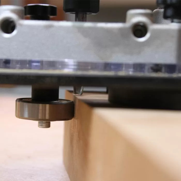 Woodworking router bit trimming the edge of a wooden board for precise joinery