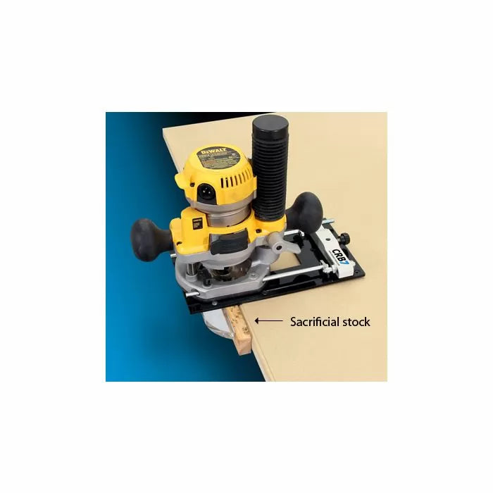 Woodworking router with edge guide and sacrificial stock on a workbench