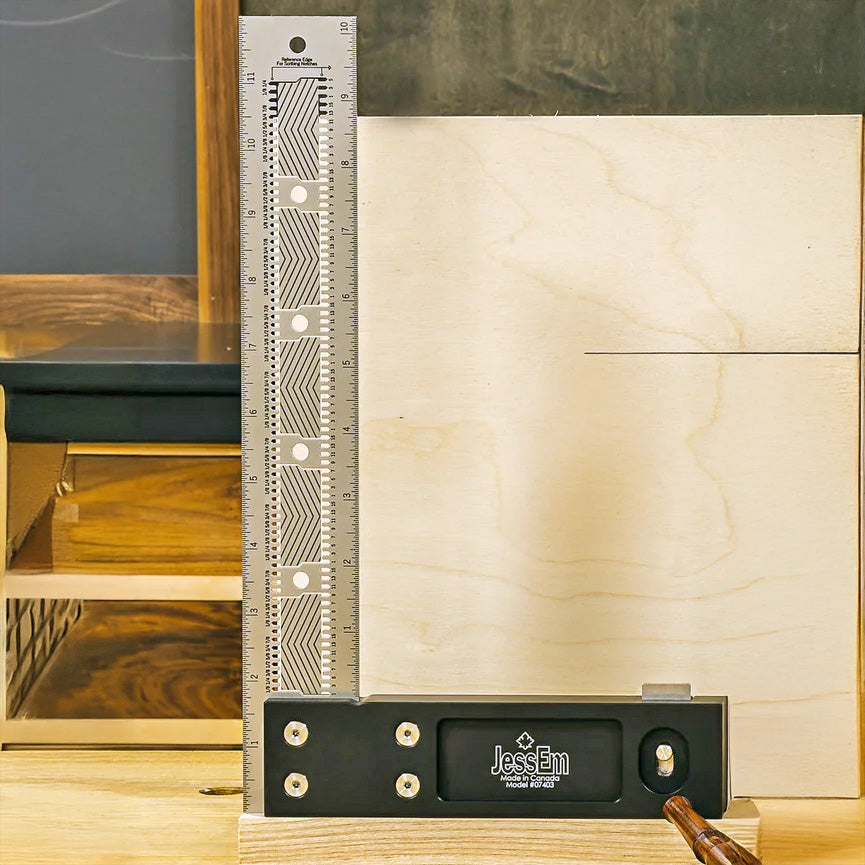Precision woodworking square tool standing upright on a woodworking bench beside plywood