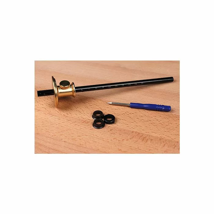 Woodworking marking gauge set with brass head, ruler, screwdriver, and washers on wood surface