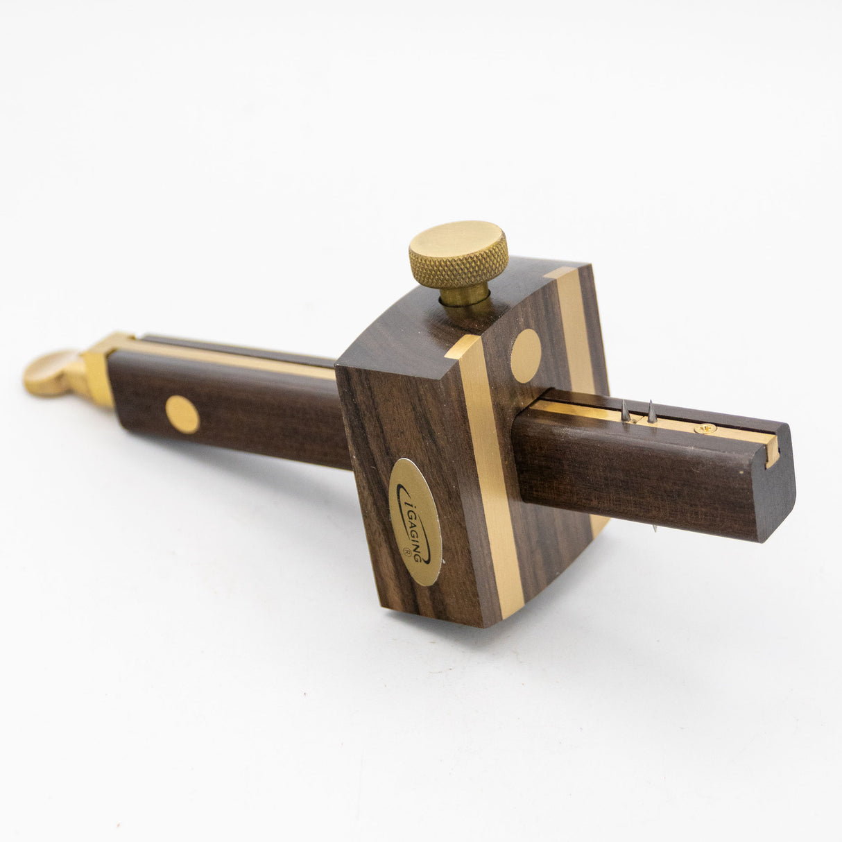 Ebony marking gauge with brass accents for woodworking on a white background