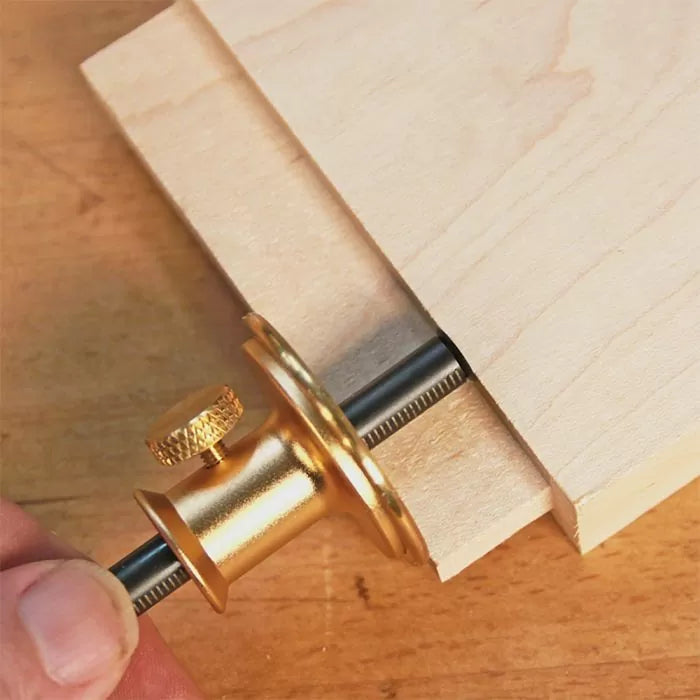 Precision marking gauge tool in use on light wood for woodworking measurement