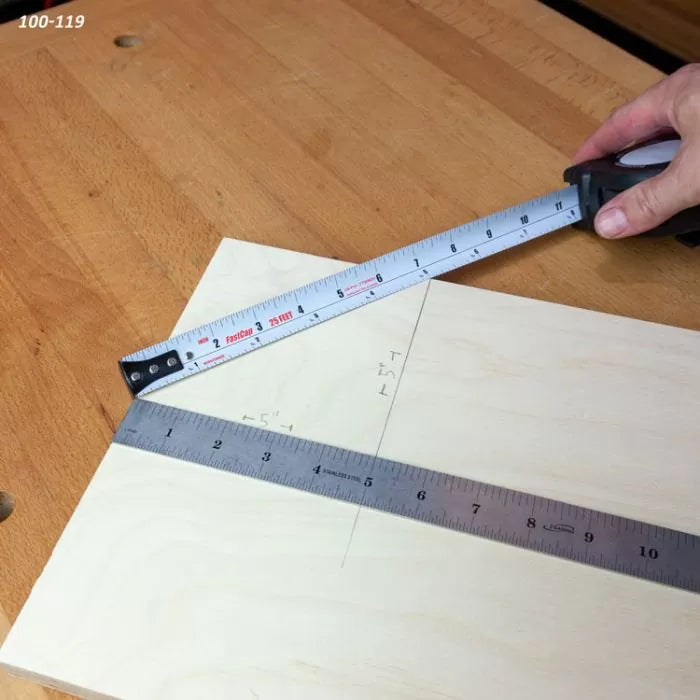 Measuring plywood with a tape measure and metal ruler on a woodworking bench