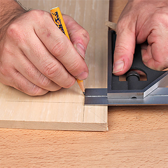 Hand marking wood with pencil and combination square for woodworking layout