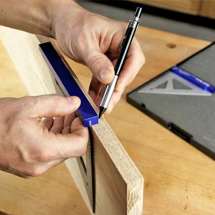 Woodworker marking precise lines on wood with a blue marking gauge and pencil