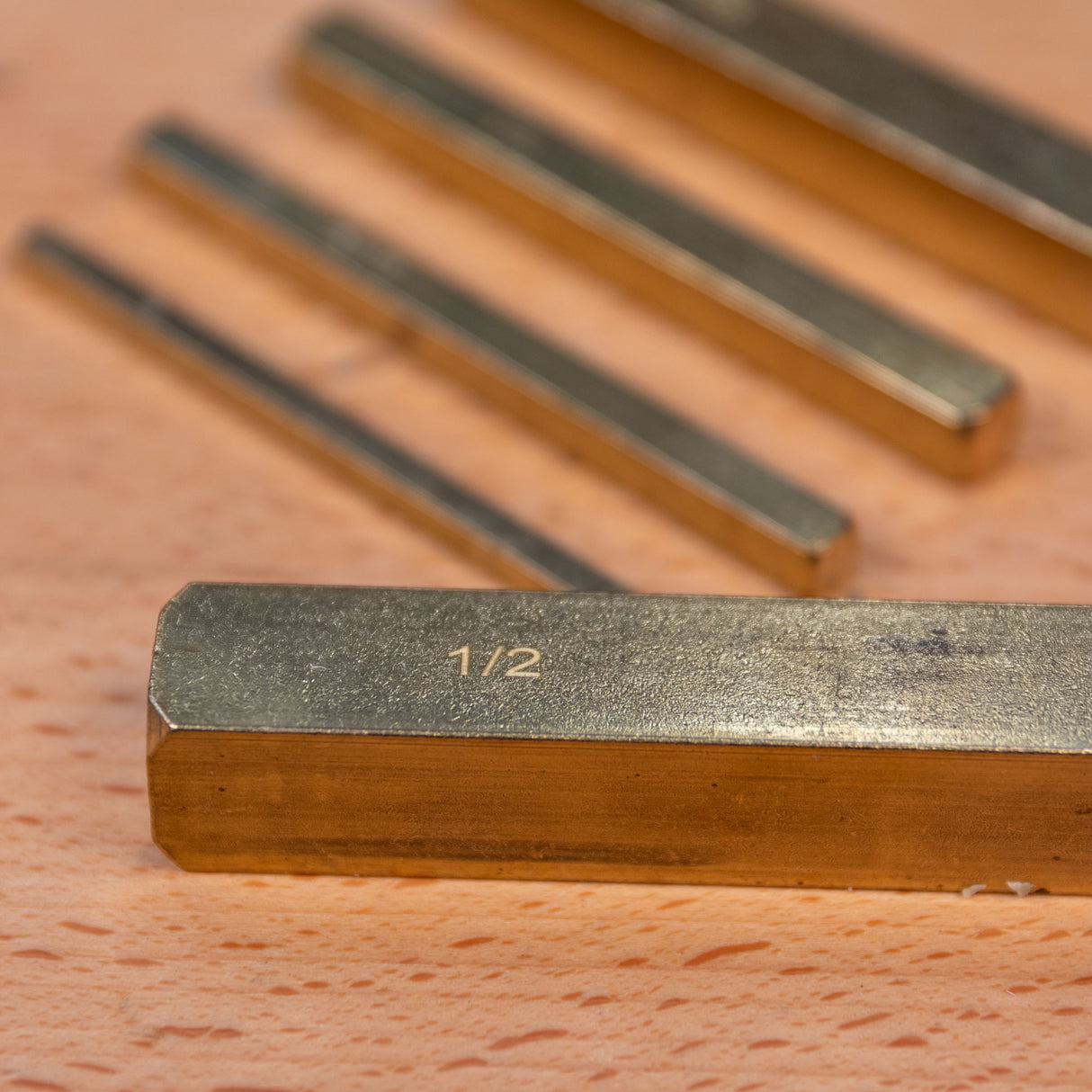 Close-up of brass setup bars with inch markings for precise woodworking measurements.