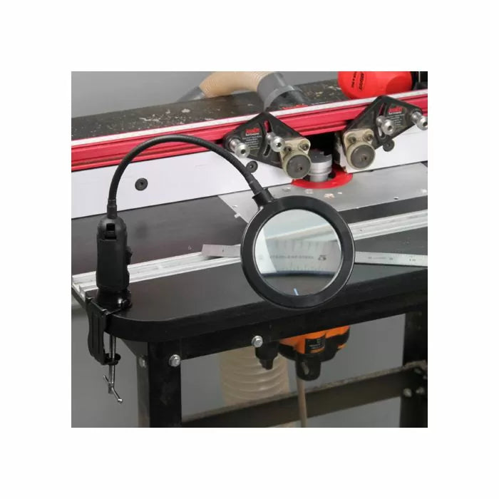 Flexible LED magnifying lamp attached to a woodworking router table