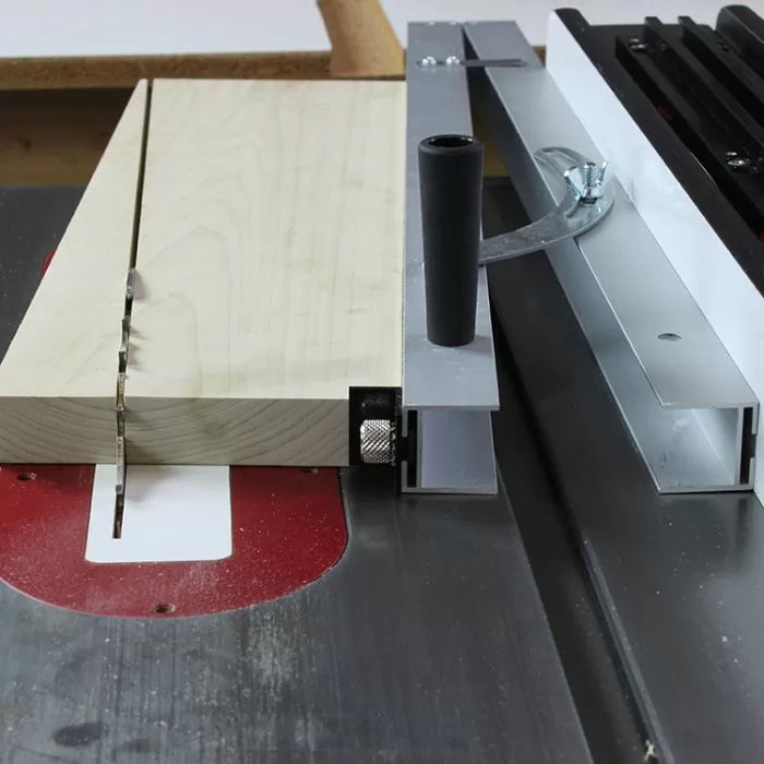 Table saw crosscut sled cutting wood with aluminum fence and handle for woodworking precision