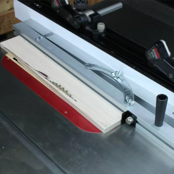 Table saw with a featherboard and fence setup for precise woodworking cuts
