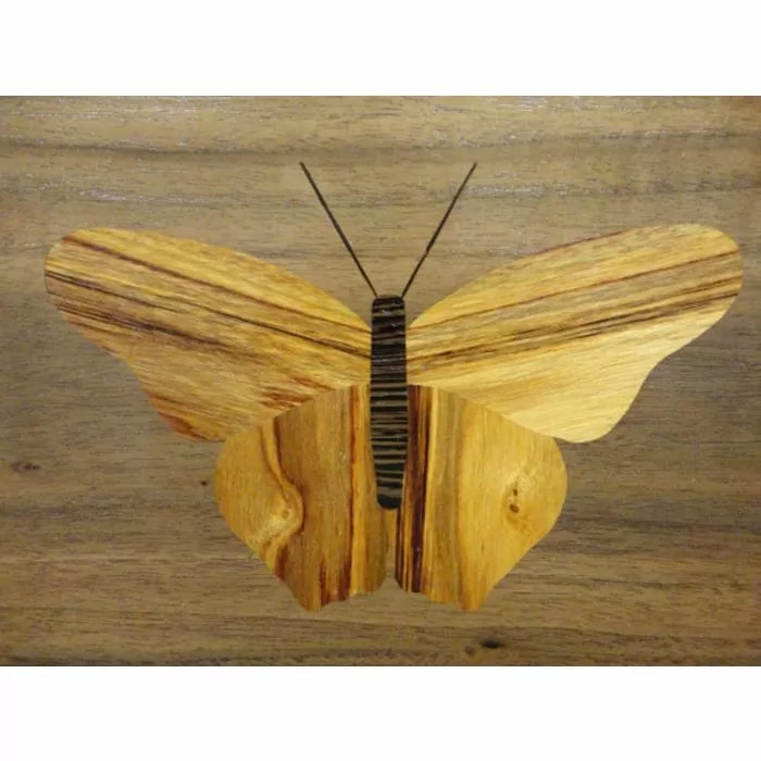Woodworking butterfly inlay design with natural grain details on wood background