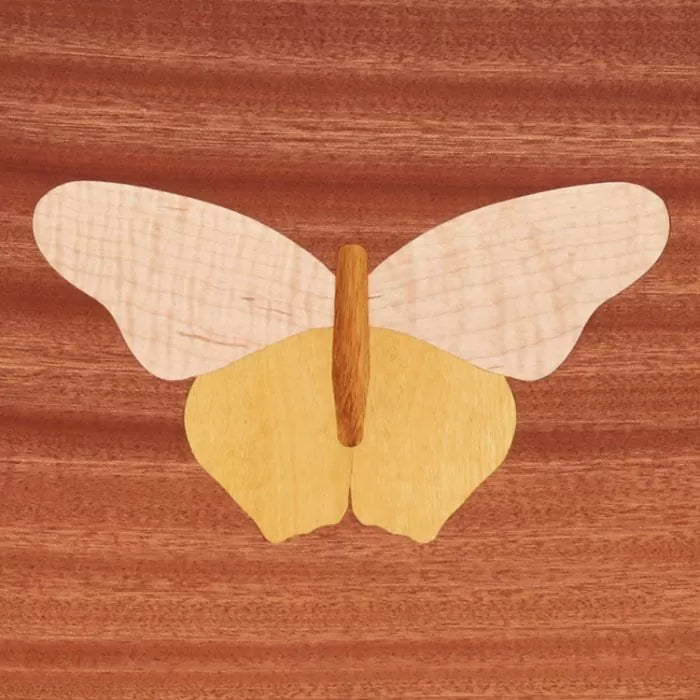 Butterfly wood inlay on a polished wooden surface, woodworking marquetry detail
