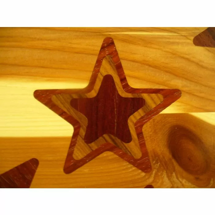 Close-up of wooden star inlay on a polished wood surface, showcasing fine woodworking detail.