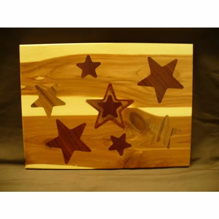 Handcrafted wooden cutting board with star-shaped inlays on a natural wood background
